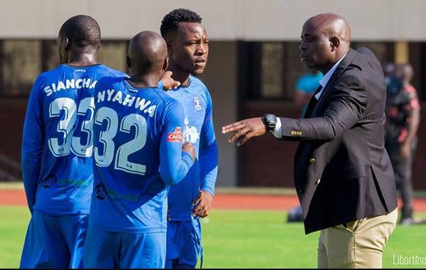 Dynamos coach Tonderai Ndiraya talking to his players during a water break.