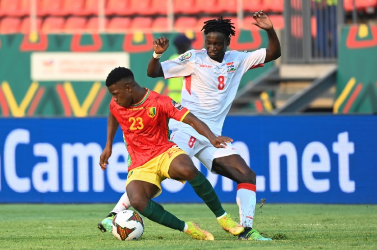 Aguibou Camara (L) of Guinea fights for the ball with Ebrima Darboe of Gambia in an Africa Cup of Nations last-16 match in Bafoussam on Monday