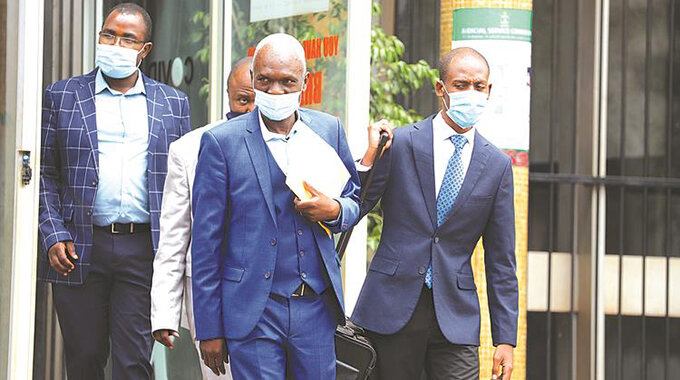 Felton Kamambo and crew leaving court in December 2021 after attending a trial in a bribe case.