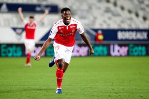 Stade de Reims midfielder Marshall Munetsi celebrating after scoring a goal in a French League 1 match.