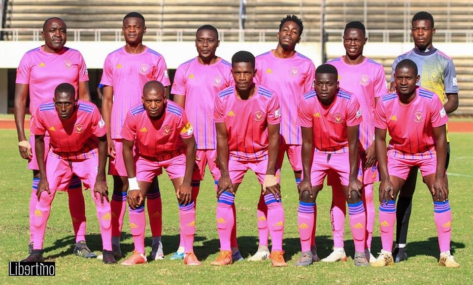 Herentals FC posing for a pre-match team photo before a game at the National Sports Stadium.
