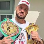 British boxer Tyson Fury showing off his British heavyweight titles which he has offered Anthony Joshua to challenge for in a bout