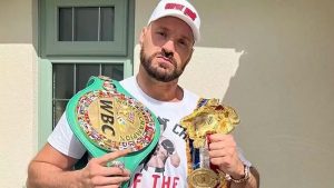 British boxer Tyson Fury showing off his British heavyweight titles which he has offered Anthony Joshua to challenge for in a bout