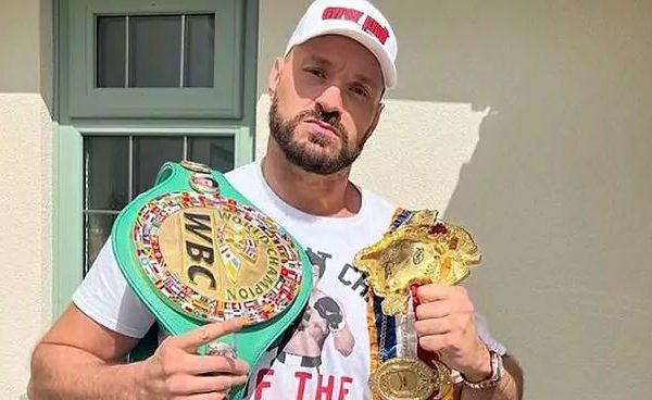 Home 166 British boxer Tyson Fury showing off his British heavyweight titles which he has offered Anthony Joshua to challenge for in a bout