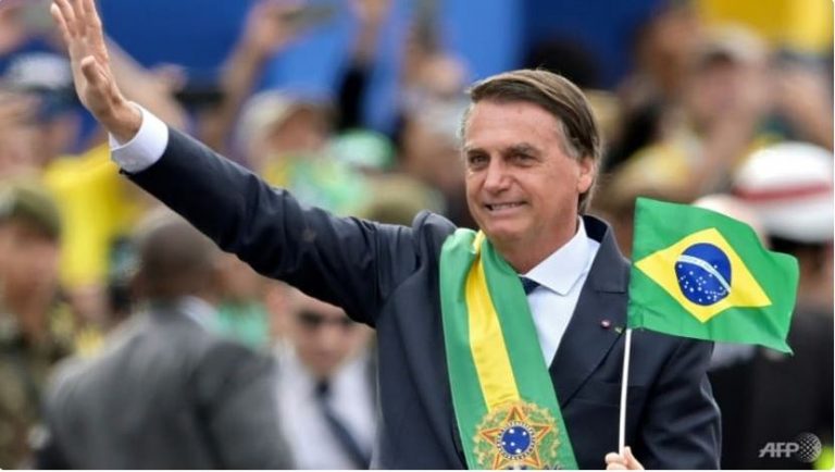 Brazilian President Jair Bolsonaro waves at the crowd during a military parade to mark Brazil's 200th anniversary of independence in Brasilia on Sep 7, 2022.