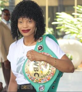 Zimbabwean boxer Kudakwashe Chiwandire posing with her WBC Interim Super bantamweight title.