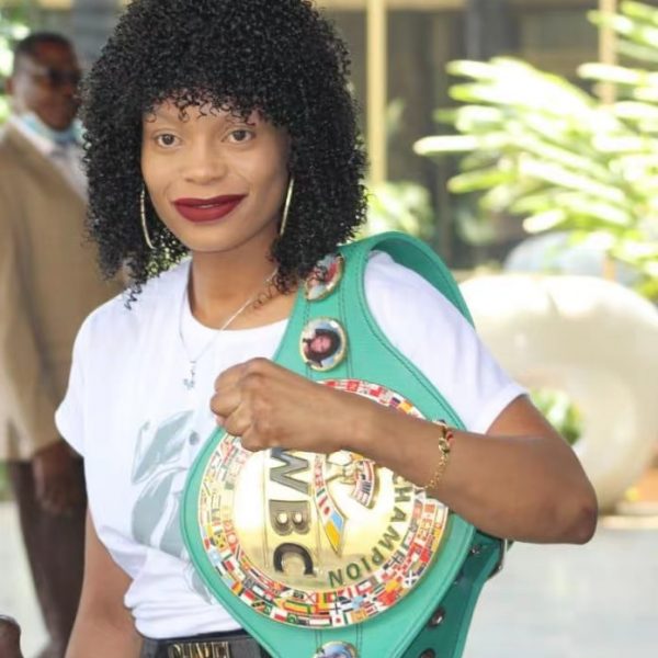 Zimbabwean boxer Kudakwashe Chiwandire posing with her WBC Interim Super bantamweight title.