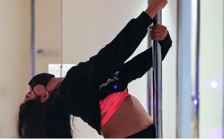 Saudi Arabia yoga instructor Nada, exercises by pole dancing at a local gymnasium in the capital Riyadh, on October 1, 2022.