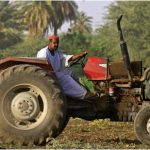 A man drives a tractor ploughing earth at a plot along the east Bank bank of the Nile river in the city of al-Jili, about 50 kilometres north of Sudan's capital Khartoum.