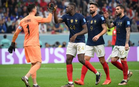 France's Ibrahima Konate, Olivier Giroud and Theo Hernandez and goalkeeper Hugo Lloris after a save during the Qatar 2022 World Cup semifinal football match between France and Morocco at the Al-Bayt Stadium in Al Khor, north of Doha on 14 December 2022.
