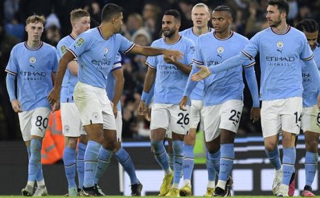 Manchester City midfielder Riyad Mahrez (C) celebrates scoring the team's second goal during the English League Cup fourth round football match between Manchester City and Liverpool, at the Etihad stadium in Manchester on 22 December 2022.