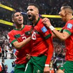 Morocco's forward #19 Youssef En-Nesyri (C) celebrates with teammates after scoring the opening goal during the Qatar 2022 World Cup quarter-final football match between Morocco and Portugal at the Al-Thumama Stadium in Doha on December 10, 2022.