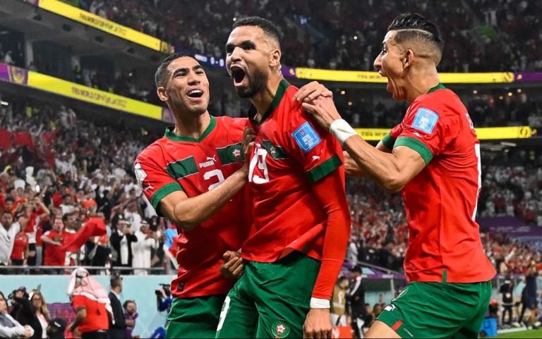 Morocco's forward #19 Youssef En-Nesyri (C) celebrates with teammates after scoring the opening goal during the Qatar 2022 World Cup quarter-final football match between Morocco and Portugal at the Al-Thumama Stadium in Doha on December 10, 2022.