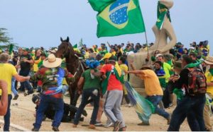 A military police officer falls from his horse during clashes with supporters of Brazilian former President Jair Bolsonaro after an invasion to Planalto Presidential Palace in Brasilia on 8 January 2023.