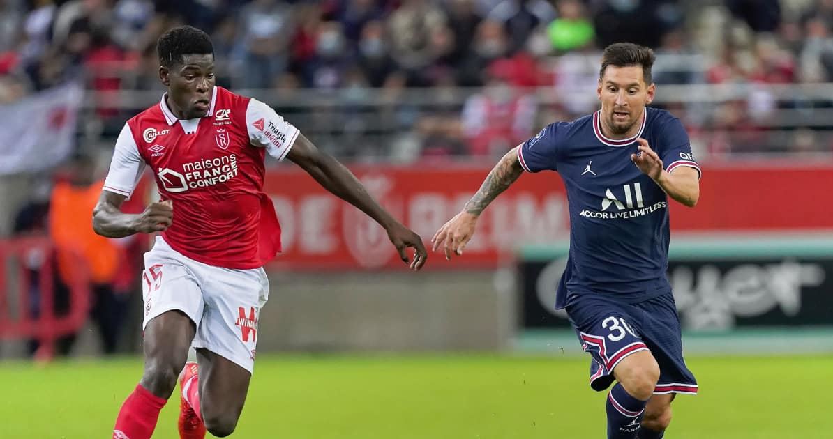 Stade Reims midfielder Marshall Munetsi tussle for the ball against PSG star Lionel Messi in a French League 1 match.