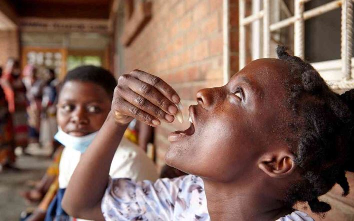 Eliza Tangwe, 18, takes a dose of oral cholera vaccine in Malawi.
