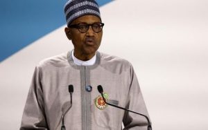 Home 5 Nigerian President Muhammadu Buhari gives a speech during the opening ceremony of the "Paris Peace Forum" at The Grande Halle de la Villette in Paris on 11 November 2021.