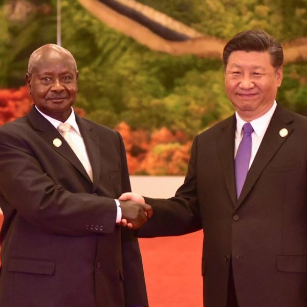 Ugandan President Yoweri Museveni and China President Xi Jinping shake hands at a state event.