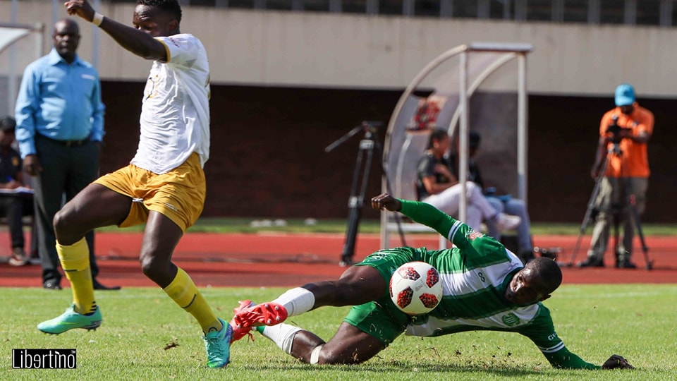 CAPS United player Joseph Thulani slides for the ball against Manica Diamonds player Bret Amidu at the National Sports Stadium on 20th March 2023.