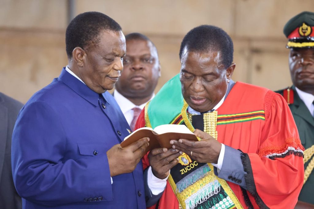 Zimbabwe President Emmerson Mnangagwa reads the bible while Vice President Constantino Chiwenga looks on during a Pastors for Economic Development Conference which was held at the City Sports Centre in Harare on Thursday 30th March 2023.