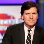 Tucker Carlson, host of “Tucker Carlson Tonight,” poses for photos in a Fox News Channel studio on March 2, 2017, in New York. Fox News says it has agreed to part ways with Tucker Carlson, less than a week.