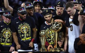 Home 8 The Denver Nuggets celebrate with the Larry O'Brien Championship Trophy after a 94-89 victory against the Miami Heat in Game Five of the 2023 NBA Finals to win the NBA Championship at Ball Arena on 12 June 2023 in Denver, Colorado.