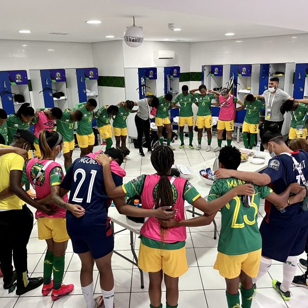 Banyana Banyana in circle team talk in the dressing room.