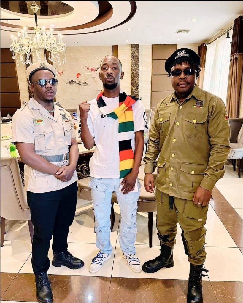 Zimbabwe music stars Poptain Yardbwoy, Holy Ten, Michael Magz pose for a photo clad in Zanu PF regalia