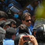 Policemen escort Pakistan's former Prime Minister Imran Khan (C) as he arrives at the high court in Islamabad on 12 May 2023. Khan appeared at court for a bail hearing on May 12, after the Supreme Court ruled unlawful his arrest this week that triggered deadly clashes across the country. Picture: Aamir QURESHI / AFP