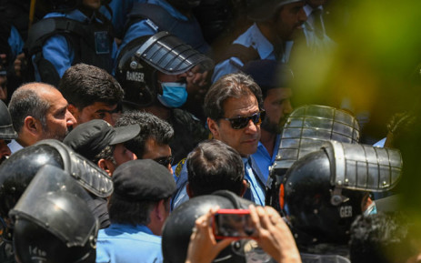 Policemen escort Pakistan's former Prime Minister Imran Khan (C) as he arrives at the high court in Islamabad on 12 May 2023. Khan appeared at court for a bail hearing on May 12, after the Supreme Court ruled unlawful his arrest this week that triggered deadly clashes across the country. Picture: Aamir QURESHI / AFP