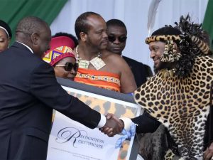 South Africa President Cyril Ramaphosa shakes hand with AmaZulu King Misuzulu kaZwelithini as he hands over a certificate of recognition at the Moses Mabhida Stadium in Durban, South Africa, on Oct. 29, 2022.