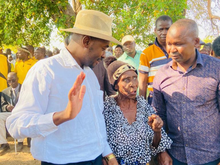 Citizens Coalition for Change (CCC) leader Nelson Chamisa and party official Prince Dubeko Sibanda chat with an elderly lady at a party meeting in Binga, Zimbabwe recently.