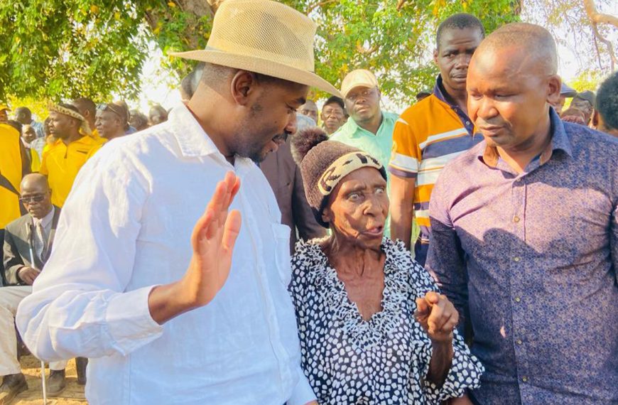Citizens Coalition for Change (CCC) leader Nelson Chamisa and party official Prince Dubeko Sibanda chat with an elderly lady at a party meeting in Binga, Zimbabwe recently.
