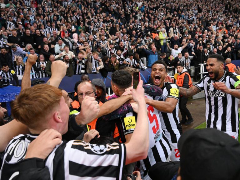 Newcastle United players celebrate a goal during their UEFA Champions League match against PSG on 4 October 2023.