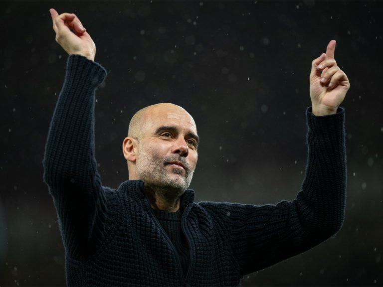 Manchester City manager Pep Guardiola celebrates with fans after a 3-0 win against Manchester United in their English Premier league match at Old Trafford on 29 October 2023.