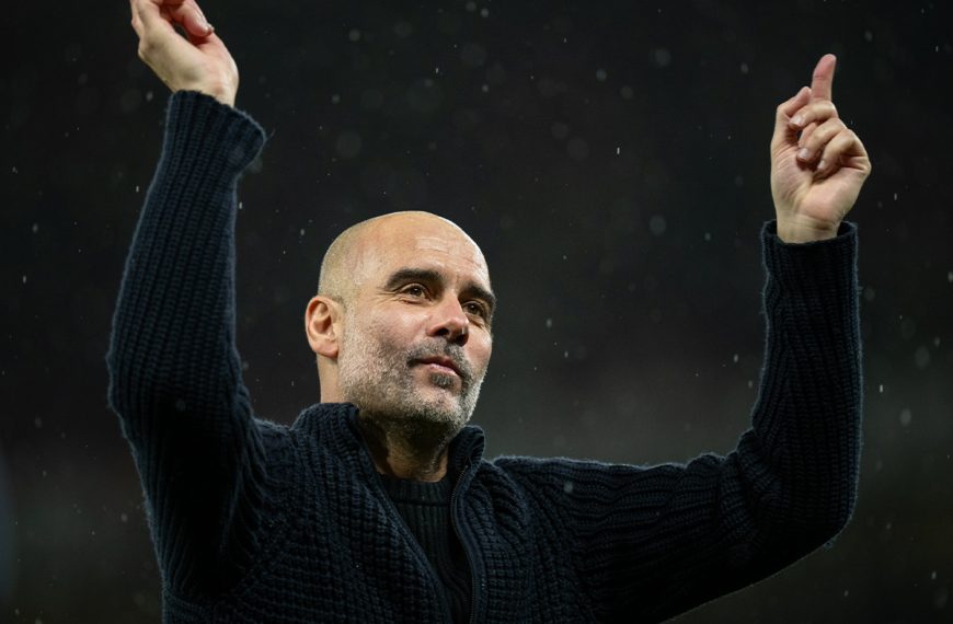 Manchester City manager Pep Guardiola celebrates with fans after a 3-0 win against Manchester United in their English Premier league match at Old Trafford on 29 October 2023.