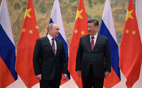 Russian President Vladimir Putin (L) and Chinese President Xi Jinping pose during their BRICS meeting in Beijing, on 4 February 2022.