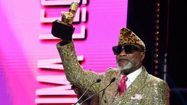 Congolese musical legend Koffi Olomide raises his award after receiving the AFRIMA legend award during the All Africa Music Awards at Eko Hotels, Victoria Island in Lagos.
