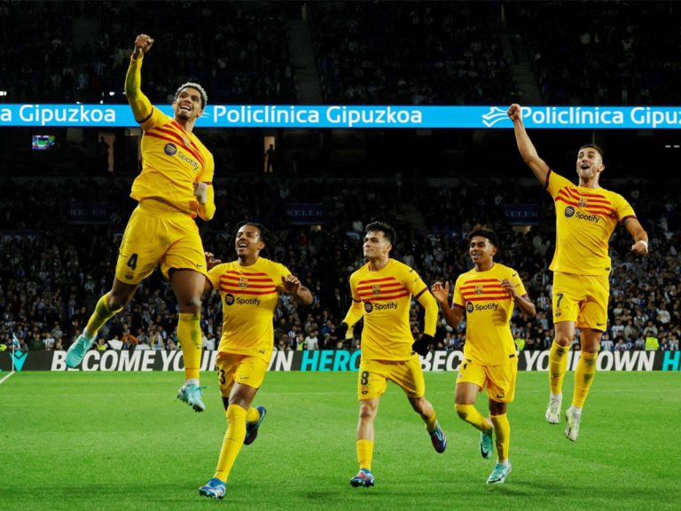 Barcelona's players celebrate after #04 Ronald Araujo scored his team's first goal during the Spanish league football match between Real Sociedad and FC Barcelona at the Anoeta stadium in San Sebastian on 4 November 2023.