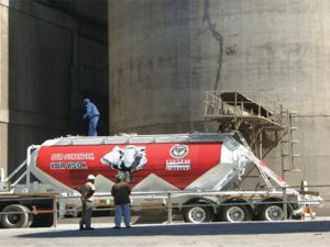 In this photo taken at PPC Zimbabwe cement plant, a machine loads cement into a truck.