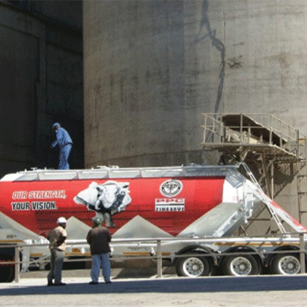 Home 30 In this photo taken at PPC Zimbabwe cement plant, a machine loads cement into a truck.