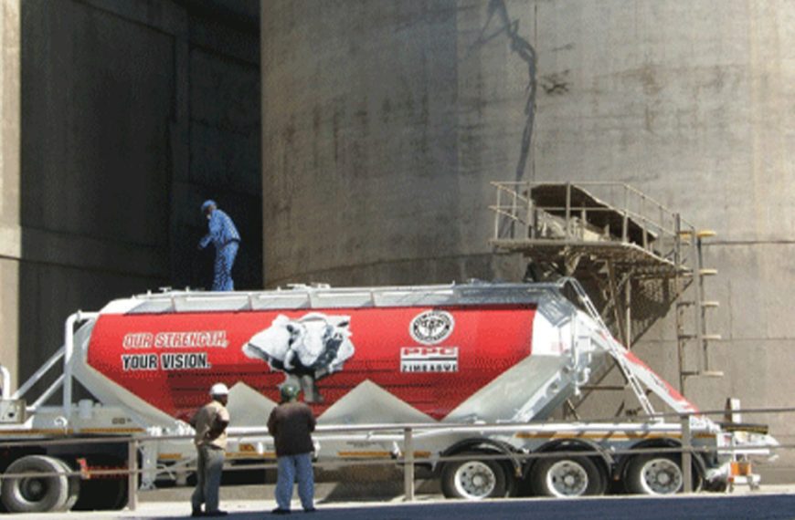 In this photo taken at PPC Zimbabwe cement plant, a machine loads cement into a truck.