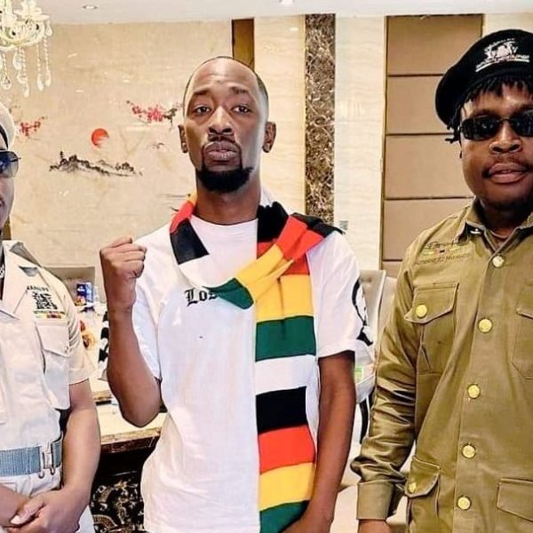 Home 154 Zimbabwe music stars Poptain Yardbwoy, Holy Ten, Michael Magz pose for a photo clad in Zanu PF regalia