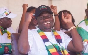 Home 8 Zanu PF apologist Scott Sakupwanya chants party slogan at a rally recently.