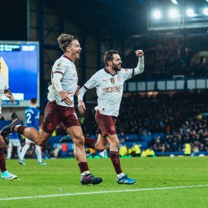 Home 6 Manchester City players Bernado Silva and Jack Grealish celebrate a goal in their 3-1 win over Everton on 27 December 2023.