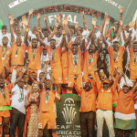 Ivory Coast's forward #15 Max-Alain Gradel (C) lifts the Africa Cup of Nations trophy on the podium after Ivory Coast won the Africa Cup of Nations (CAN) 2024 final football match between Ivory Coast and Nigeria at Alassane Ouattara Olympic Stadium in Ebimpe, Abidjan on 11 February 2024.