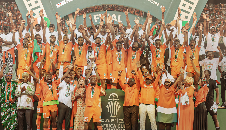 Ivory Coast's forward #15 Max-Alain Gradel (C) lifts the Africa Cup of Nations trophy on the podium after Ivory Coast won the Africa Cup of Nations (CAN) 2024 final football match between Ivory Coast and Nigeria at Alassane Ouattara Olympic Stadium in Ebimpe, Abidjan on 11 February 2024.