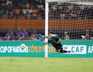 Home 5 Ronwen Williams (1) of South Africa saves a penalty during the 2023 Africa Cup of Nations Finals match between South Africa and DR Congo in Ivory Coast on 10 February 2024 ©Samuel Shivambu/ BackpagePix