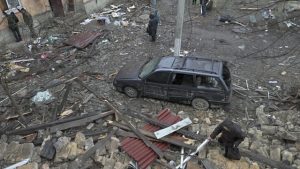 Home 8 Local residents stand among debris in the courtyard of a residential building damaged by a missile attack in the town of Selydove, Donetsk region, on February 8, 2024, amid the Russian invasion of Ukraine. (Photo by Genya SAVILOV / AFP)